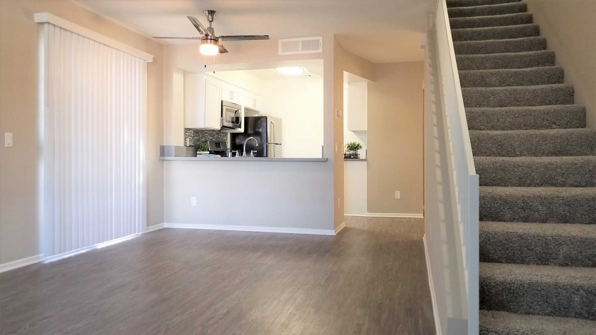 Townhomes on Emerson open living room area with stairs leading to kitchen