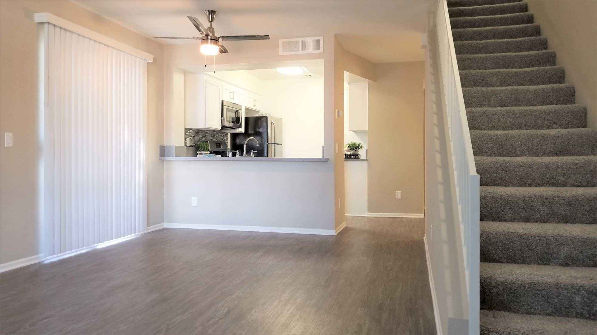 Townhomes on Emerson open living room area with stairs leading to kitchen
