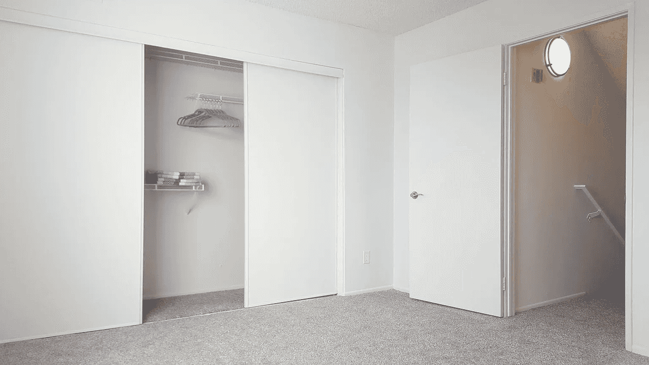 bedroom view leading to hallway and stairs